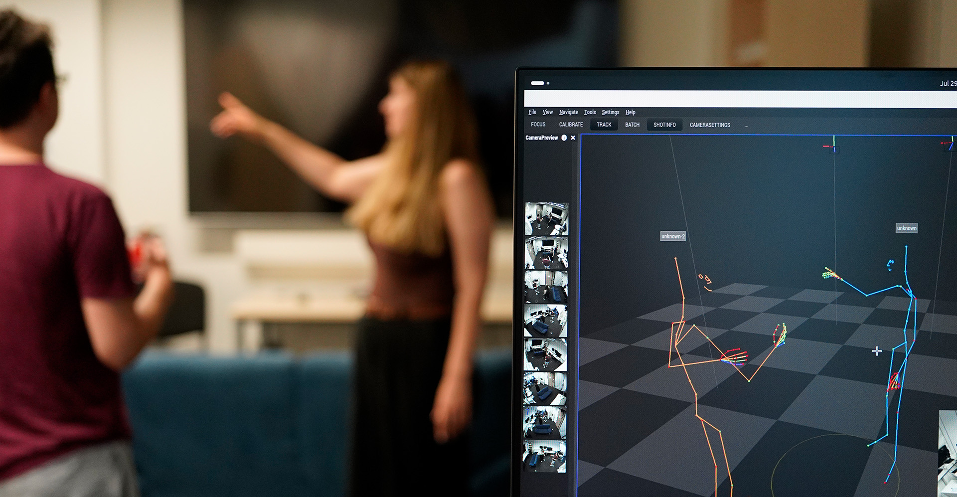 Understanding Creative Gestures: Two people standing blurred in the background, a screen in the foreground shows their tracked virtual 3d-skeletons.